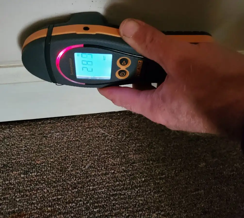 Moisture detection at baseboard during Storm Damage Restoration in Shawnee